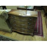 A GEORGIAN STYLE MAHOGANY CHEST of serpentine outline the shaped moulded top above four long