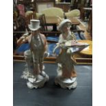 A PAIR OF ROYAL DUX FIGURES modelled as a gentleman and his companion each shown standing she