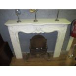 AN ART DECO STYLE WHITE MARBLE CHIMNEY PIECE the serpentine moulded shelf above a figural carved