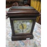 A STAINED BEECHWOOD MANTLE CLOCK of rectangular form the silvered and brass dial raised on a