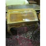 A CONTINENTAL WALNUT KINGWOOD AND GILT BRASS MOUNTED DESK of bombe outline the shaped moulded top