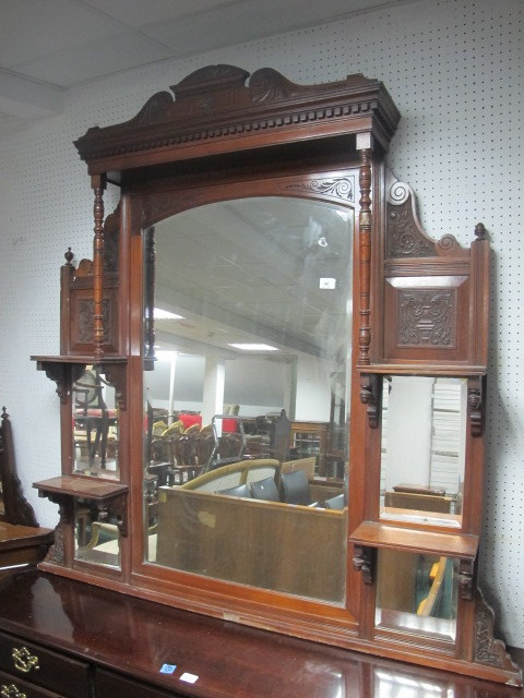 AN EDWARDIAN MAHOGANY OVERMANTEL COMPARTMENT MIRROR with bevelled glass plates and moulded shelves