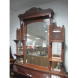 AN EDWARDIAN MAHOGANY OVERMANTEL COMPARTMENT MIRROR with bevelled glass plates and moulded shelves