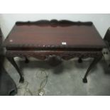 A CHIPPENDALE STYLE MAHOGANY SIDE TABLE the rectangular top with gadrooned rim above a carved