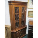 A GEORGIAN STYLE MAHOGANY CORNER CABINET the dentil moulded cornice above a pair of astragal glazed