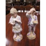 A PAIR OF BISQUE FIGURES modelled as a young girl and her companion she holding a conch shell he
