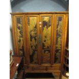 A CHINESE HARDWOOD AND GILT DECORATED CUPBOARD the moulded cornice above a pair of carved doors