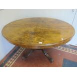 A VICTORIAN WALNUT AND SATINWOOD INLAID TABLE the oval moulded top raised on four ring turned