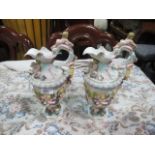 A PAIR OF MEISSEN JUGS each moulded in high relief with frolicking puttis with scroll handle on