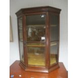 AN EDWARDIAN MAHOGANY AND GLAZED DISPLAY CABINET the rectangular top with canted angles and glazed