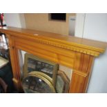 A PINE FIRE SURROUND the rectangular shelf with dentil moulded frieze raised on moulded jabs with