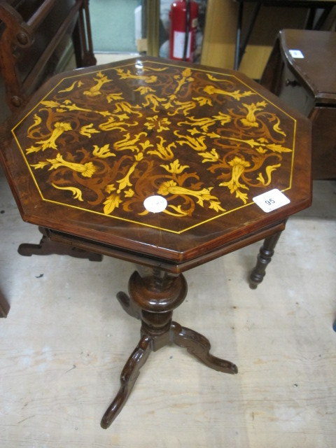 A CONTINENTAL WALNUT WORK TABLE of octagonal form the shaped moulded lid above a tapering column on