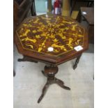 A CONTINENTAL WALNUT WORK TABLE of octagonal form the shaped moulded lid above a tapering column on