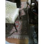 A WOOL RUG the light pink and rust ground with central rectangular panels with stylized foliage