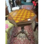 A BEECHWOOD GAMES TABLE of octagonal form with hinged lid raised on a baluster support and tripod