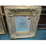 A PAIR OF CONTINENTAL GILT FRAME MIRRORS each with a bevelled glass plate within a flowerhead and