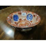 AN ORIENTAL BOWL the wine and white ground decorated with dragons stylized foliage and floweheads