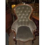 A VICTORIAN MAHOGANY UPHOLSTERED GENT'S CHAIR the arched top rail above a button upholstered panel