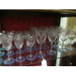 A SUITE OF TWENTY FOUR STEMMED GLASSES painted with stylized flowerheads and foliage