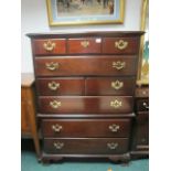 A STAINED BEECHWOOD SIX DRAWER TALLBOY with brass drop handles on ogee bracket feet 143cm (h) x