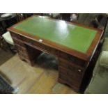 A WALNUT PEDESTAL DESK the rectangular top with tooled leather inset above three frieze drawers
