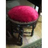 AN EDWARDIAN MAHOGANY REVOLVING STOOL the circular upholstered seat on reeded and ring turned legs