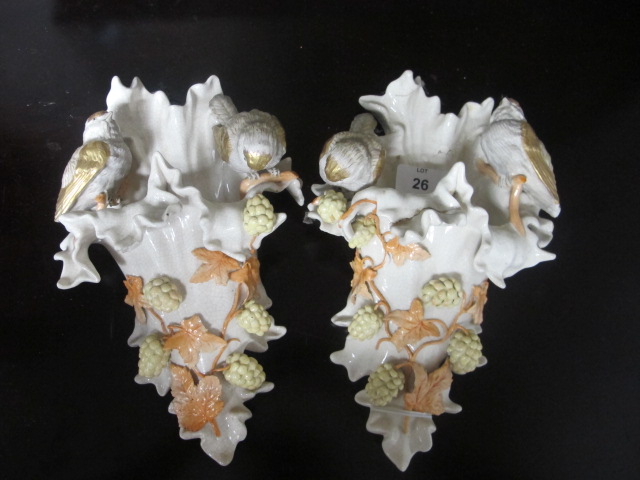 A PAIR OF GERMAN PORCELAIN WALL POSIES decorated with fruiting vines and birds shown perched 26cm