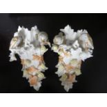 A PAIR OF GERMAN PORCELAIN WALL POSIES decorated with fruiting vines and birds shown perched 26cm