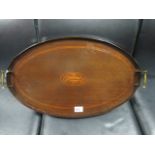 AN EDWARDIAN MAHOGANY AND SATINWOOD INLAID TRAY of oval outline with moulded gallery and brass