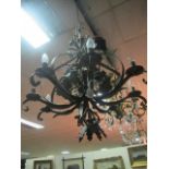 A CONTINENTAL GILT METAL BRANCH CHANDELIER the open work basket filled with flowerheads and foliage