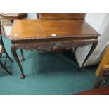 A CHIPPENDALE STYLE MAHOGANY SIDE TABLE the rectangular top with gadrooned rim above a carved