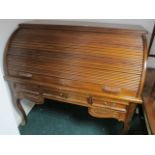 A WALNUT AND MAHOGANY CYLINDER DESK the rectangular top above a tambour shutter containing pigeon