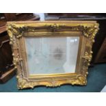 A CONTINENTAL GILT FRAME MIRROR the rectangular bevelled plate within a flowerhead and foliate