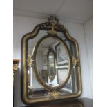 A CONTINENTAL GILTWOOD AND PAINTED MIRROR the rectangular shaped plate containing an oval bevelled
