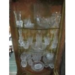 THREE SHELVES OF CUT GLASS to include Waterford, Cavan and Dublin crystal decanters, vases,