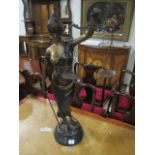 A BRONZE FIGURE modelled as a female shown standing holding a scales aloft 80cm high