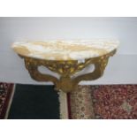 A CONTINENTAL CARVED GILTWOOD CONSOLE TABLE of demi-lune outline surmounted with a vein marble top