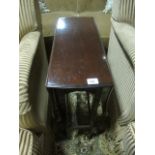 AN EDWARDIAN MAHOGANY SUTHERLAND TABLE the serpentine hinged top raised on duel moulded uprights