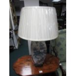 A PORCELAIN TABLE LAMP the white and blue ground decorated with flowerheads and foliage raised on a