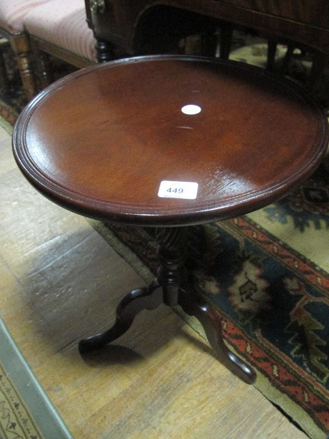 A MAHOGANY WINE TABLE the circular dish top above a baluster column on tripod support 55cm (h) x
