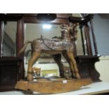 A CARVED WOOD ROCKING HORSE of typical form