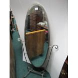 A WROUGHT IRON CHEVAL MIRROR with scroll decoration 156cm (h) x 73cm (w)