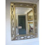 A SILVER FRAMED MIRROR the rectangular bevelled glass plate within a lattice work frame 123cm x