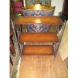 A METAL THREE TIER STAND of rectangular form with leather inset raised on cylindrical supports on