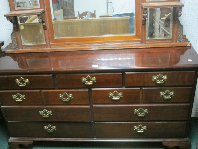 A STAINED BEECHWOOD LOWBOY the rectangular top above an arrangement of seven drawers with brass