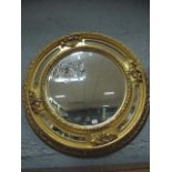 A CONTINENTAL GILTWOOD AND GESSO MIRROR the circular bevelled glass plate within a foliate and