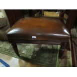 A REGENCY STYLE MAHOGANY UPHOLSTERED STOOL the rectangular upholstered seat and reeded tapering