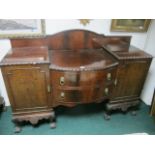 A CHIPPENDALE STYLE MAHOGANY SIDEBOARD of rectangular bowed outline with two frieze drawers and