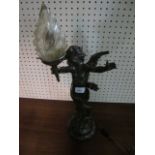 AFTER AUGUSTOS MOREALL A BRONZED TABLE LAMP in the form of a winged cherub holding a torch aloft