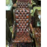 A PAIR OF MAHOGANY AND HIDE UPHOLSTERED ROCKING CHAIRS each with deep button upholstered back and